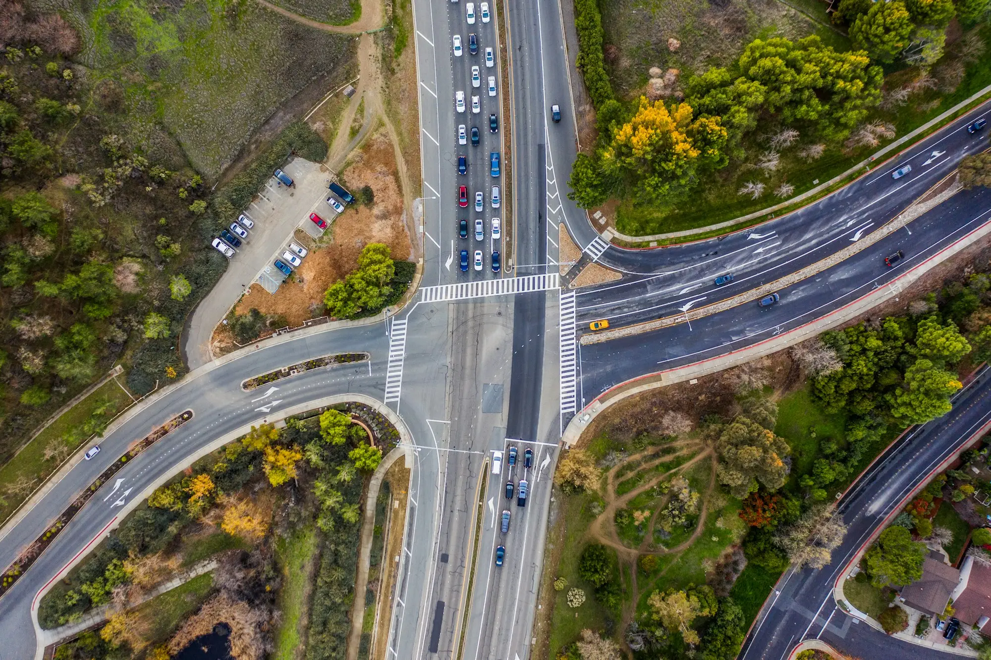 Aerial view of a four-way intersection in Concord, California, with vehicles, turning lanes, and crosswalks.